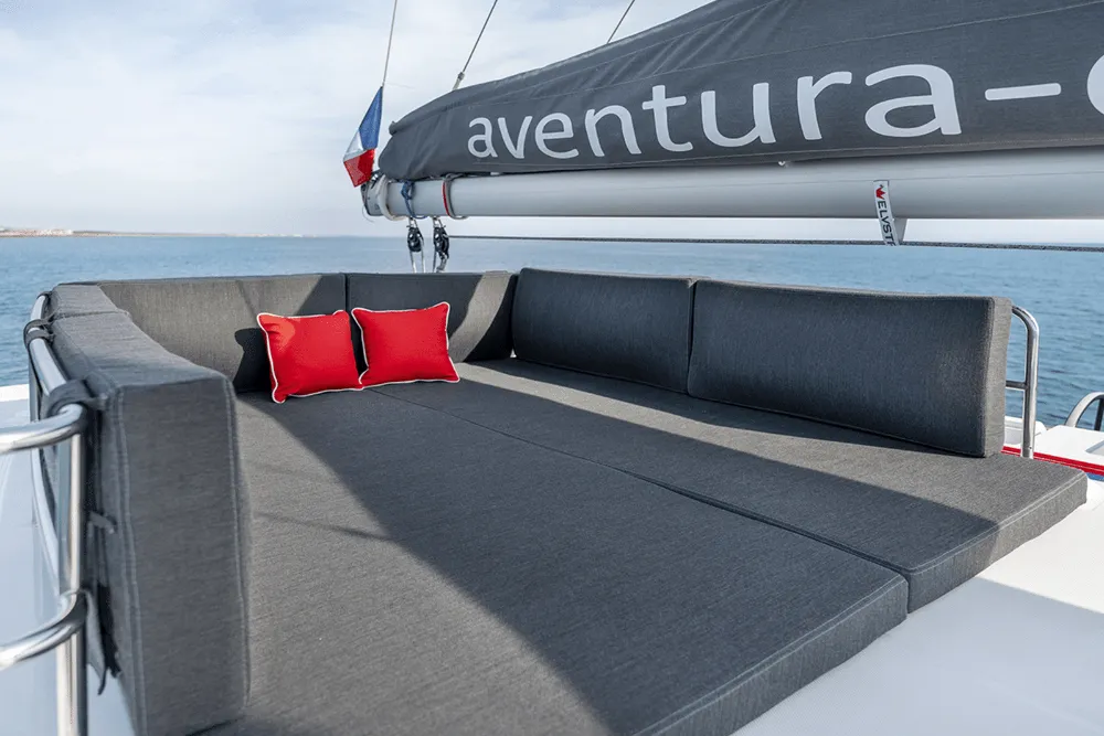 Upper Flybridge area with helm station and seating on the catamaran.
